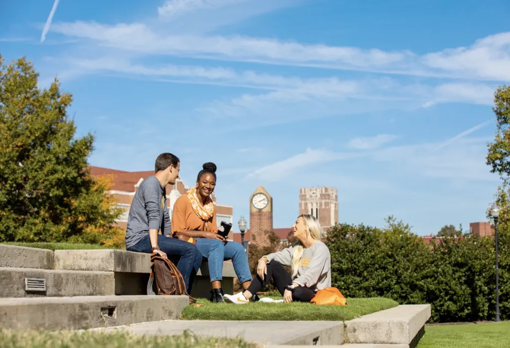Students chatting while sitting on steps on UT's campus